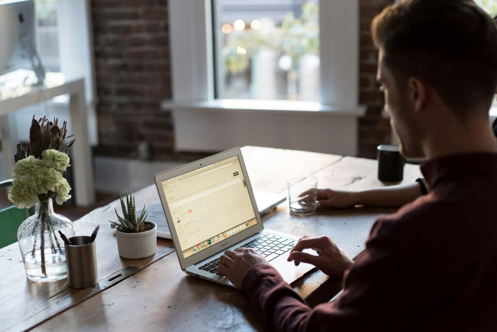 a man using a laptop working on email marketing