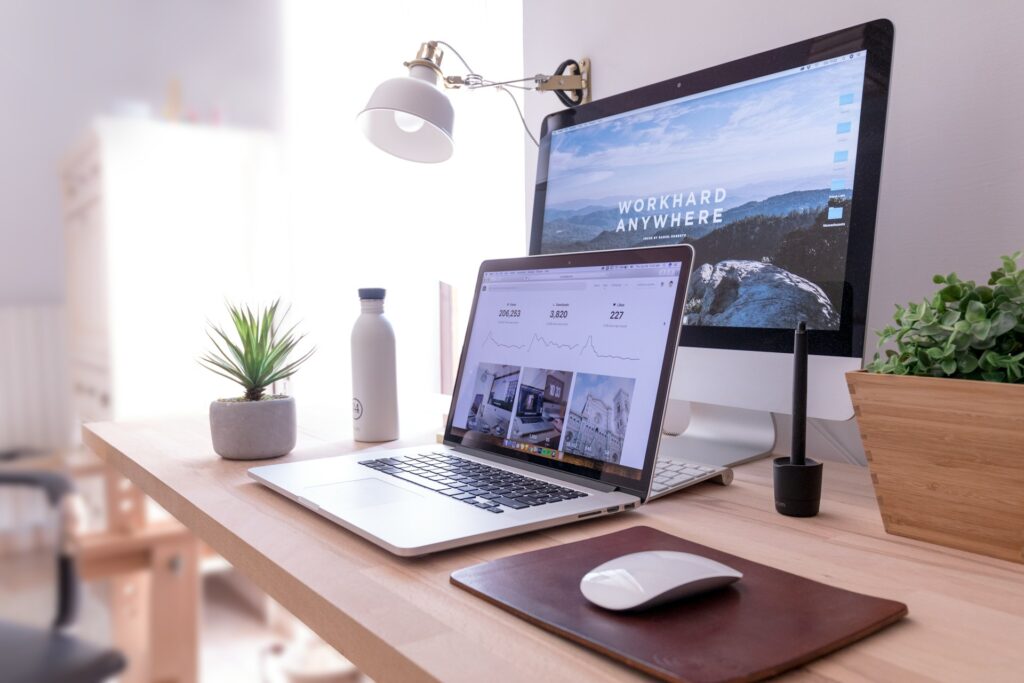 a laptop on a desk showing different website designs