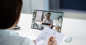 a woman holding a paper doing an interview to hire Virtual Assistant