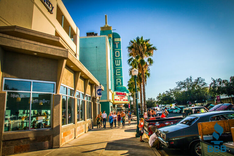 a group of people walking on a sidewalk of a Roseville business area