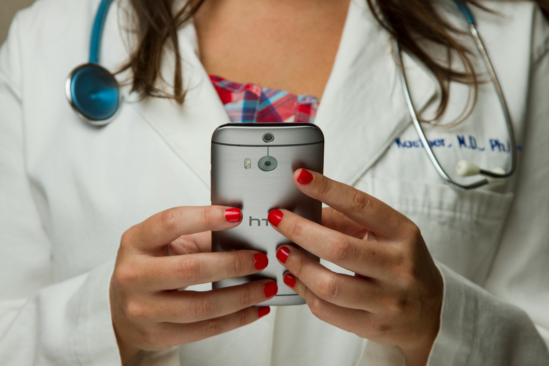 Clinician in a medical office holding a smartphone