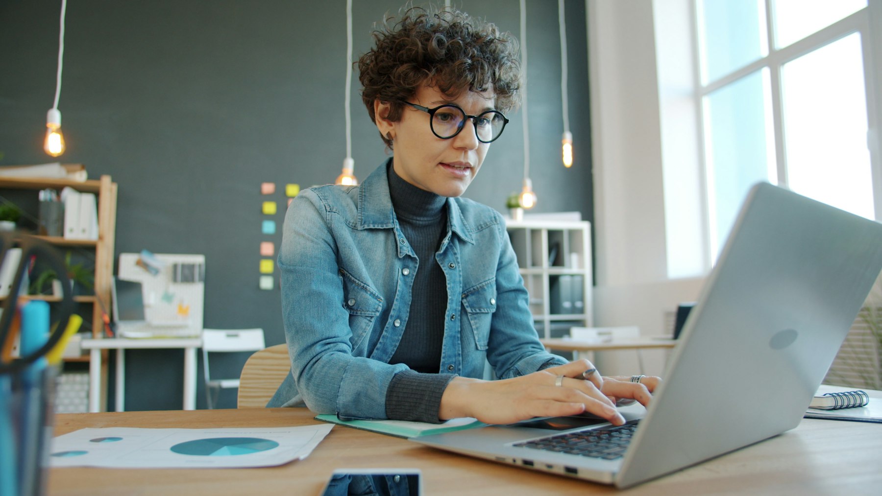 Practice owner concentrating on a laptop at an office desk