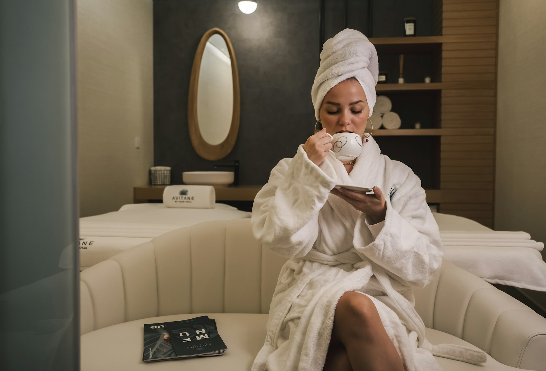 Client in a robe relaxing in a modern med spa treatment lounge