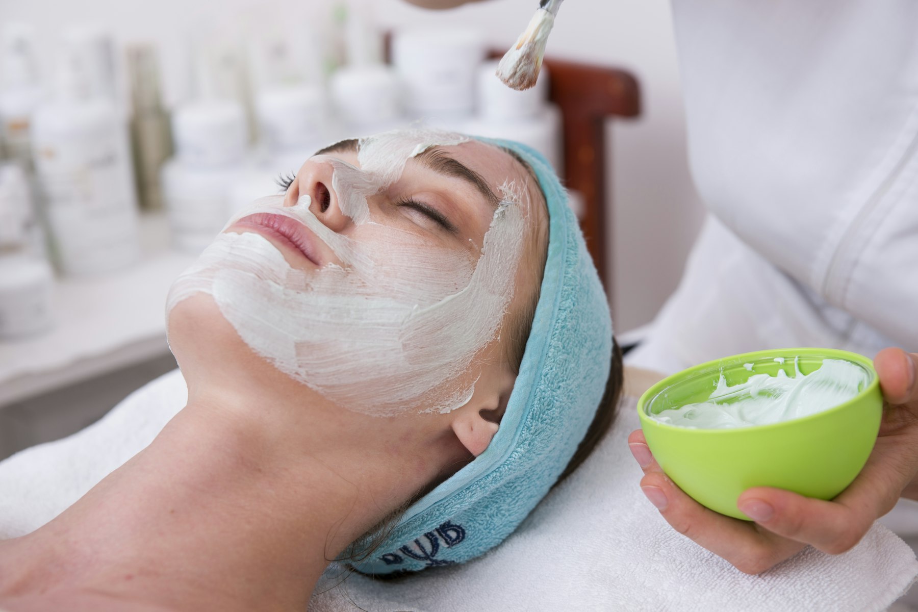 Woman receiving a facial skincare treatment at a bright med spa