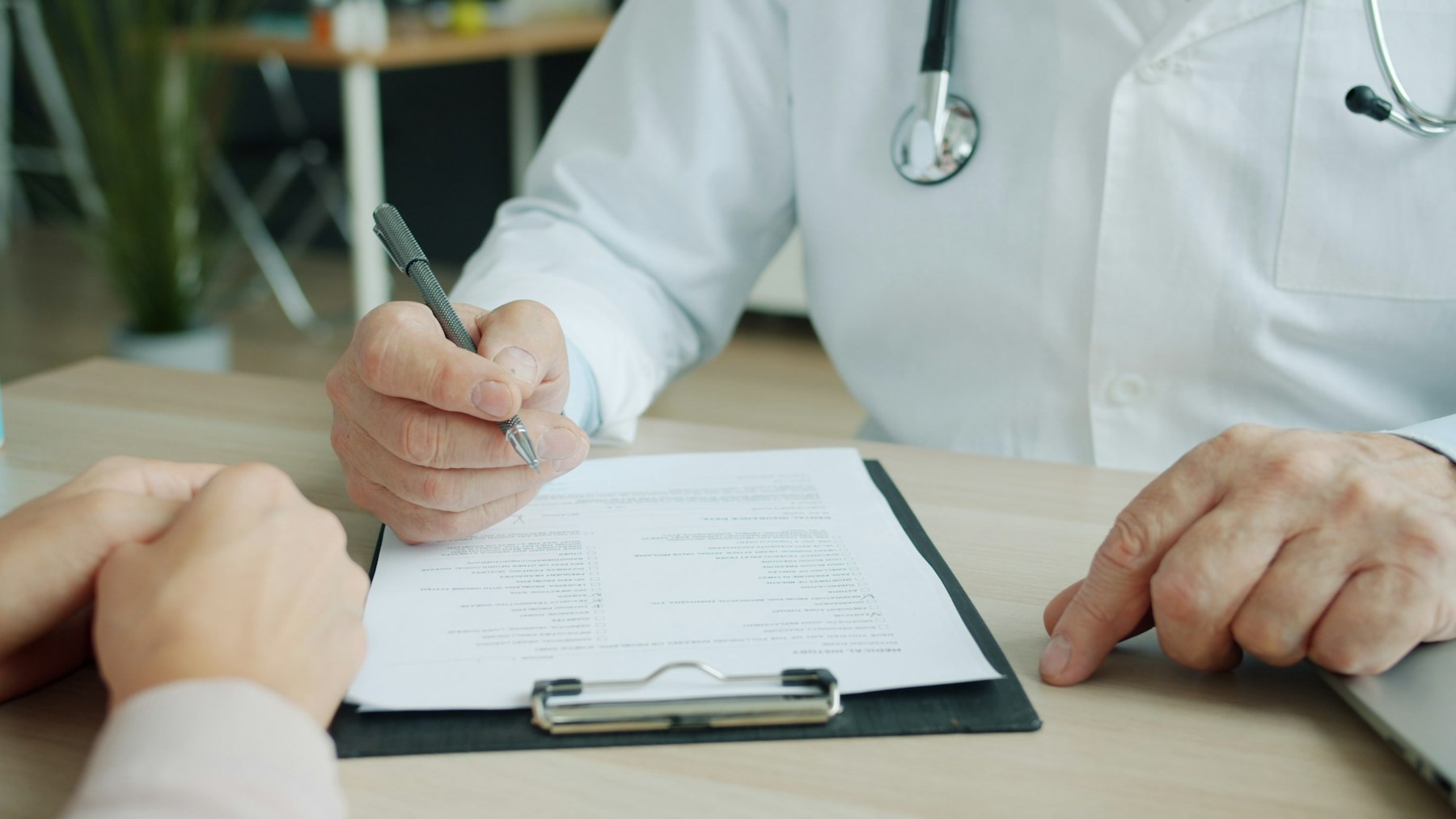 Doctor reviewing a patient's chart with her during an appointment